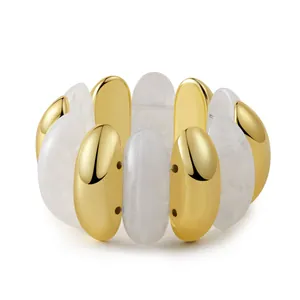 Detail of bohemian stretch bracelet with gold metal bars and marble resin beads