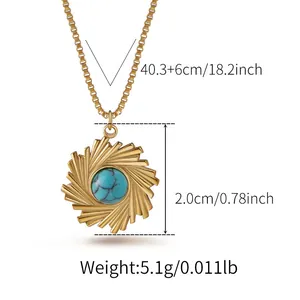 Detail view of gold sunburst pendant necklace with turquoise bead and size measurements