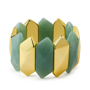 Detailed view of geometric hexagonal resin prisms and golden metal links on a stretch bracelet