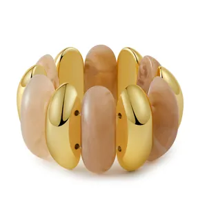 Detail of bohemian gold-plated metal and marbled resin bead stretch bracelet design