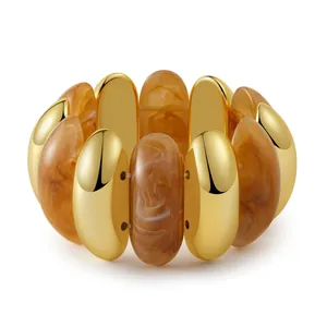 Detailed macro view of elastic beaded bracelet with amber resin and gold metal tubes
