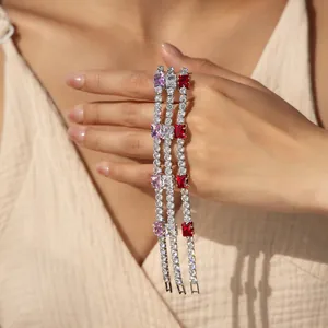 Detailed shot of three colorful 18K gold plated tennis bracelets on a woman's wrist