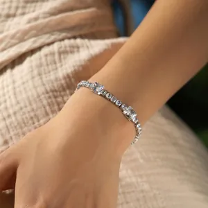 Macro view of silver tennis bracelet featuring alternating round and square cubic zirconia