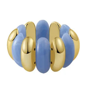 Bohemian stretch bracelet featuring golden metal and sky blue resin link design