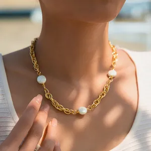 Elegant 18K gold plated chain necklace featuring three baroque pearls on a female model