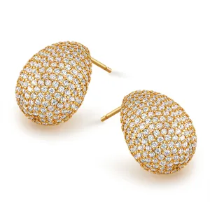 Detailed view of oval gold stud earrings with sparkling pave-set cubic zirconia crystals