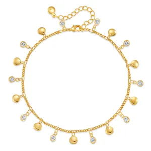 Close-up of 18K gold plated anklet with polished discs and clear zircon pendants