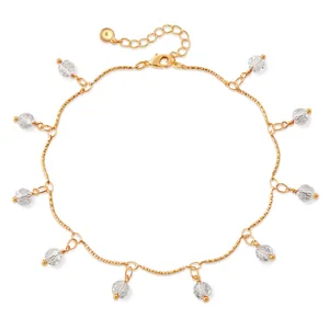 Detail of 18K gold-plated anklet with textured chain and faceted clear crystal charms
