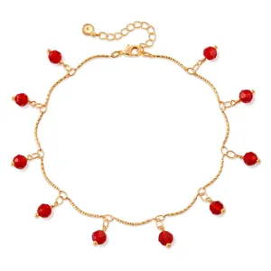 Detail of 18K gold plated anklet featuring faceted red crystal beads and lobster clasp