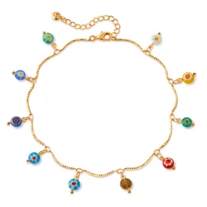 Macro detail of 18K gold-plated anklet featuring colorful millefiori floral glass beads