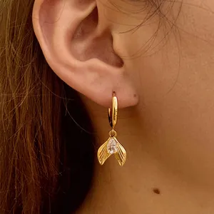 Chic gold hoop earrings with textured mermaid tail pendants and teardrop zircon crystal