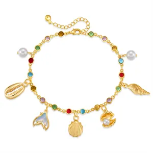 Detail of gold starfish anklet with colorful rhinestones, shell charms, and pearl accents