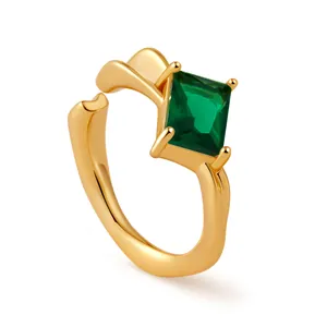 Detail view of 18K gold ring featuring a square-cut green zircon in a classic 4-prong setting