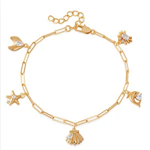 Bracelet de cheville doré avec pendentifs étoile de mer et coquillages aux cristaux brillants