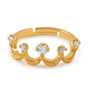 Detailed view of an 18K gold crown ring featuring five zircons and adjustable open band