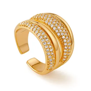 Detailed close-up of a three-tier 18K gold ring with micro-set zircon accents