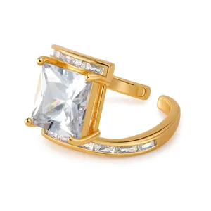 Close-up of 18K gold open ring featuring a large square zircon and side accents