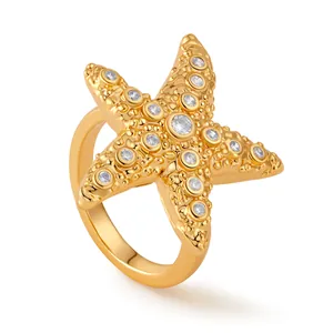 Detailed view of the 18K gold starfish ring featuring zircon accents and ocean-inspired texture