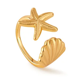 Macro detail of 18K gold plated starfish and scallop shell on open adjustable ring