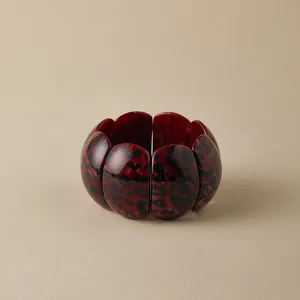 Detailed view of irregular oval leopard print resin bracelet with flexible elastic cord