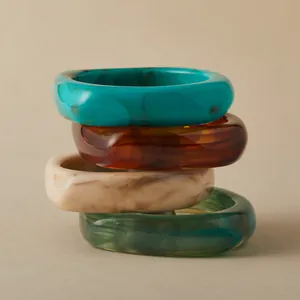 Set of four thick acrylic resin bangles with tortoiseshell and marble patterns