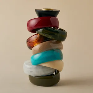 Stack of colorful vintage acrylic geometric resin bangles in various elegant earthy tones