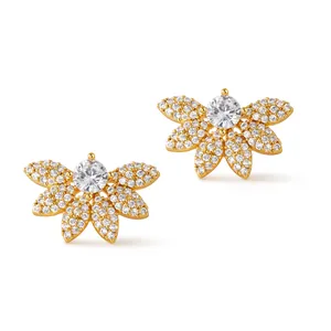 Macro shot of 18K gold plated floral stud earrings with shimmering zircon pavé petals