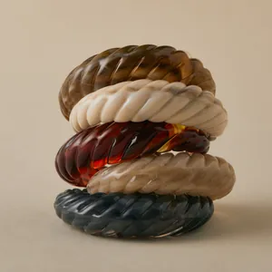 Detailed macro view of five vintage twisted acrylic resin bangles in diverse colors