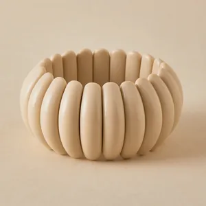 Macro shot of minimalist beige resin tile bracelet with smooth polished finish
