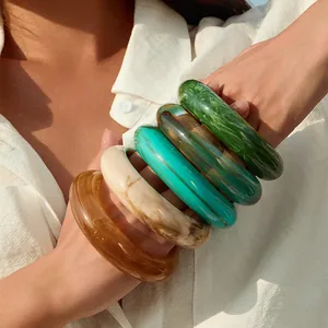 Chunky acrylic resin bangles with colorful marble patterns and retro bold design