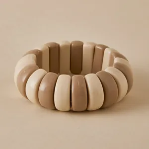 Detailed view of elastic beaded bracelet with beige and coffee acrylic segments