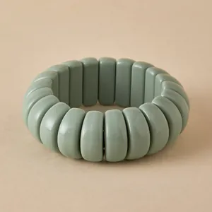 Close-up of Macaron green beaded bracelet with smooth resin rectangular tiles