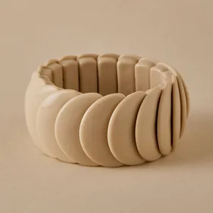 Close-up of a wide chunky cream resin stretch bracelet featuring a minimalist sleek design