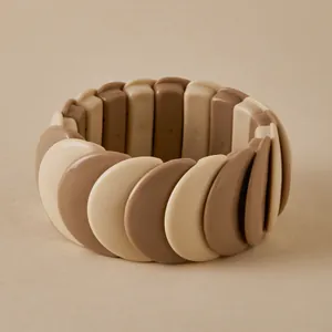Macro view of elastic tile bracelet in earth tones showing smooth acrylic texture