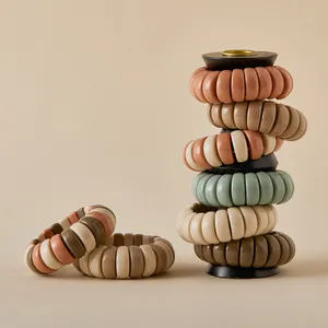 Morandi colors spiral phone cord hair ties set on a minimalist wooden display stand