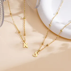 Elegant gold stainless steel necklace featuring letter pendants with polished beads