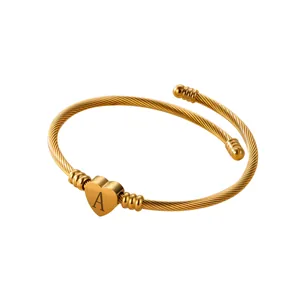 Gold-plated braided heart bangle with letter A engraving on white background