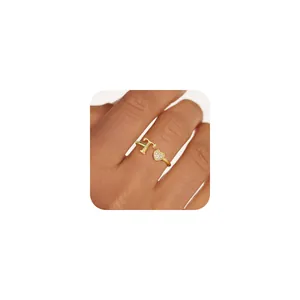 Close-up of golden T-letter ring with pavé heart zirconia on a finger display