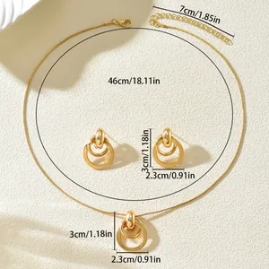 Golden geometric necklace and earrings set with intersecting circles on white background
