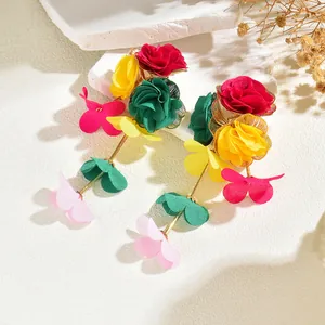 Detailed view of colorful multi-layered chiffon flower drop earrings with golden metal studs