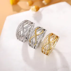 Detailed view of layered infinity rings featuring pave-set zircon in gold and silver