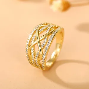 Golden multi-layer crisscross ring with pavé-set zircons and hollow geometric design