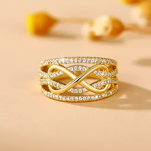Detailed view of infinity symbol gold ring set with sparkling white cubic zirconia