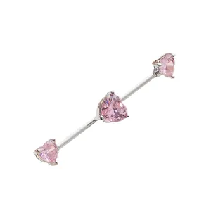 Industrial barbell piercing with three pink heart cubic zirconia in silver finish