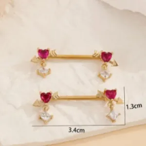 Detailed view of cupid arrow nipple rings with red heart zircons and square pendants