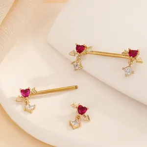 Golden heart-shaped nipple shield rings with red crystals and cubic zirconia accents