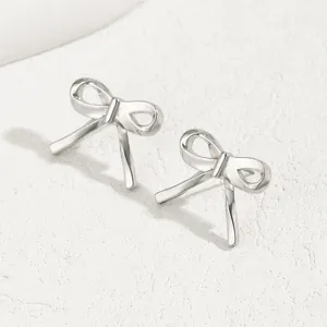 Elegant 3D bow stud earrings in silver metal with a polished finish for women