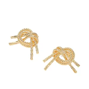 Minimalist gold knot stud earrings with realistic woven texture in a polished finish