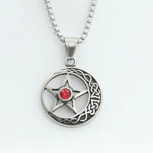 Detail of punk star pendant with red zircon stone and silver-tone box chain necklace