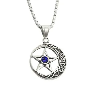 Detail of vintage steel crescent moon pendant with celtic knot and blue star zircon